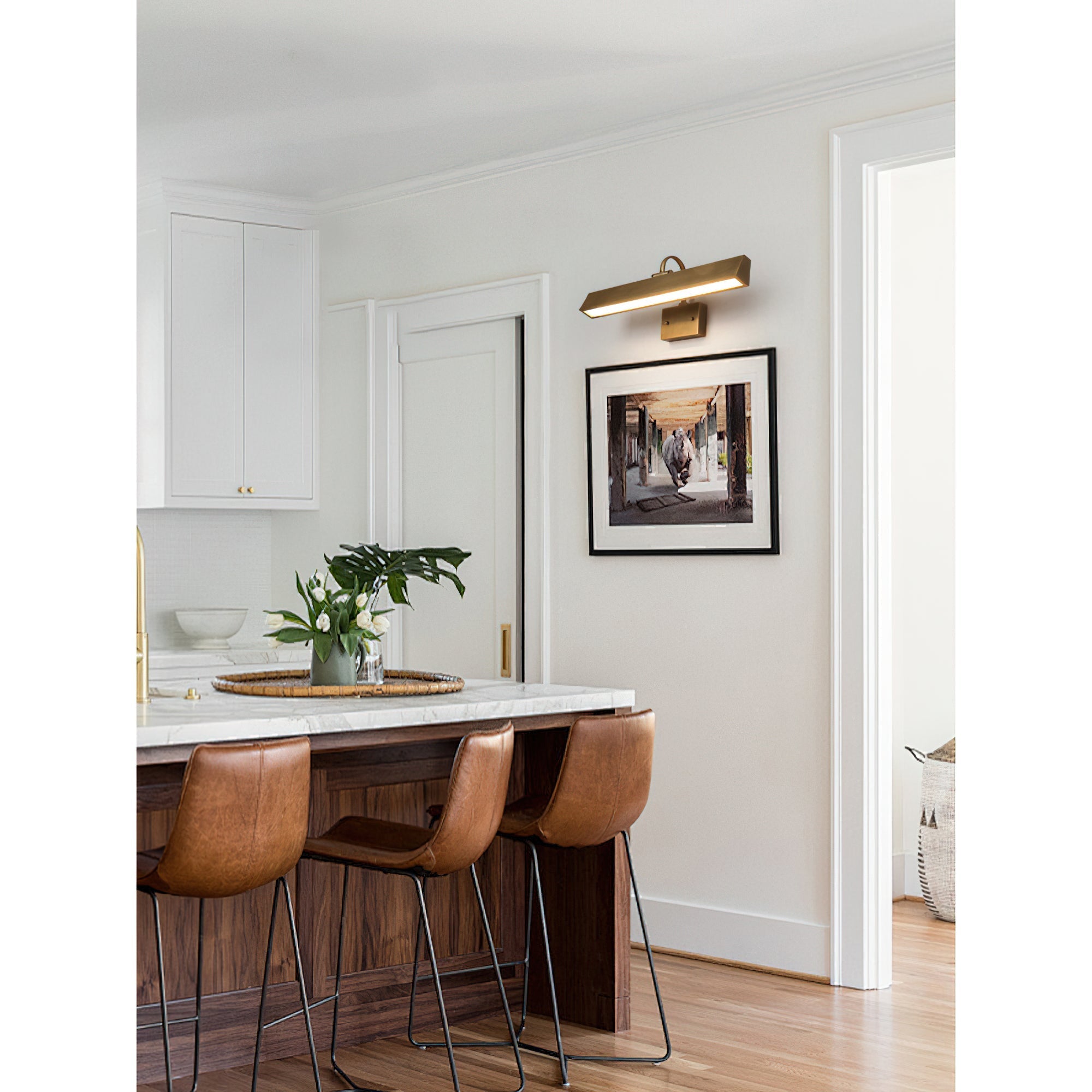 Arti Brass Wall Sconce in a library setting.