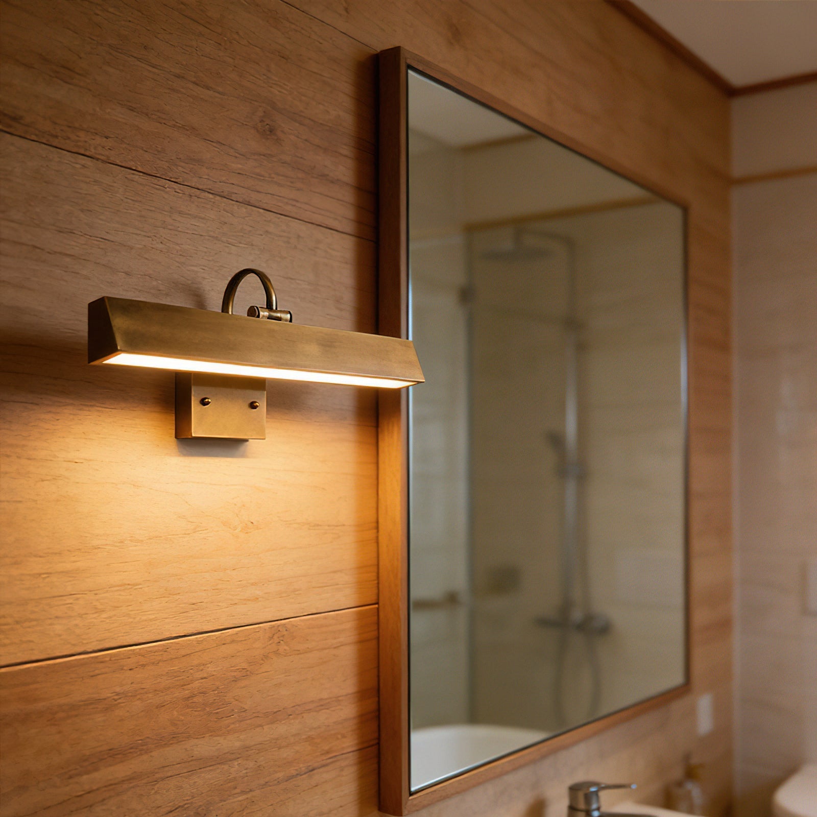 Arti Brass Wall Sconce installed above a painting.