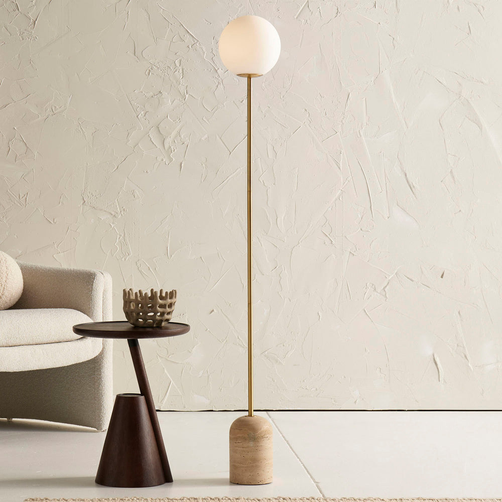Close-up of the solid travertine stone base of the Aseneth floor lamp.