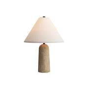 Astere Travertine Table Lamp with a conical fabric shade on a side table.