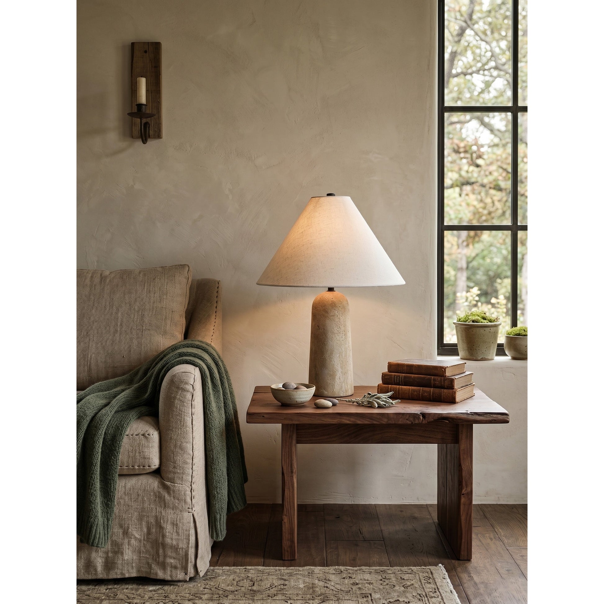 The Astere lamp shown against a neutral, textured wall.