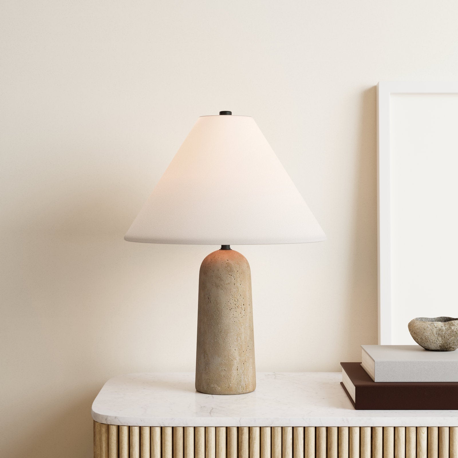 Close-up of the porous, textured travertine stone base of the Astere lamp.
