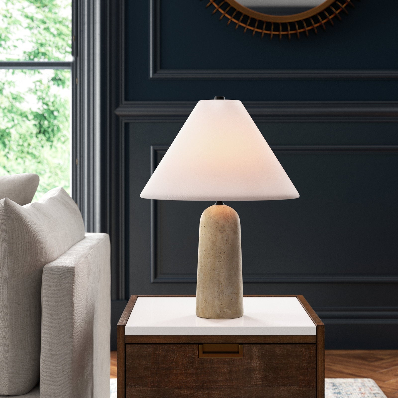 The pill-shaped solid travertine base of the Astere lamp.