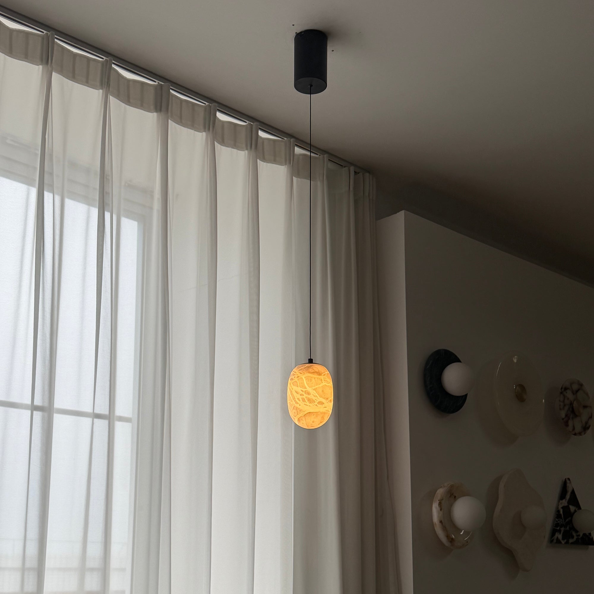 Aurora pendant lamp as a centerpiece over a dining table.