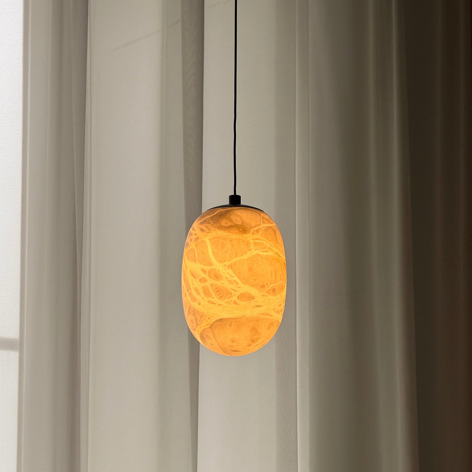 The lamp unlit, highlighting its sculptural form.