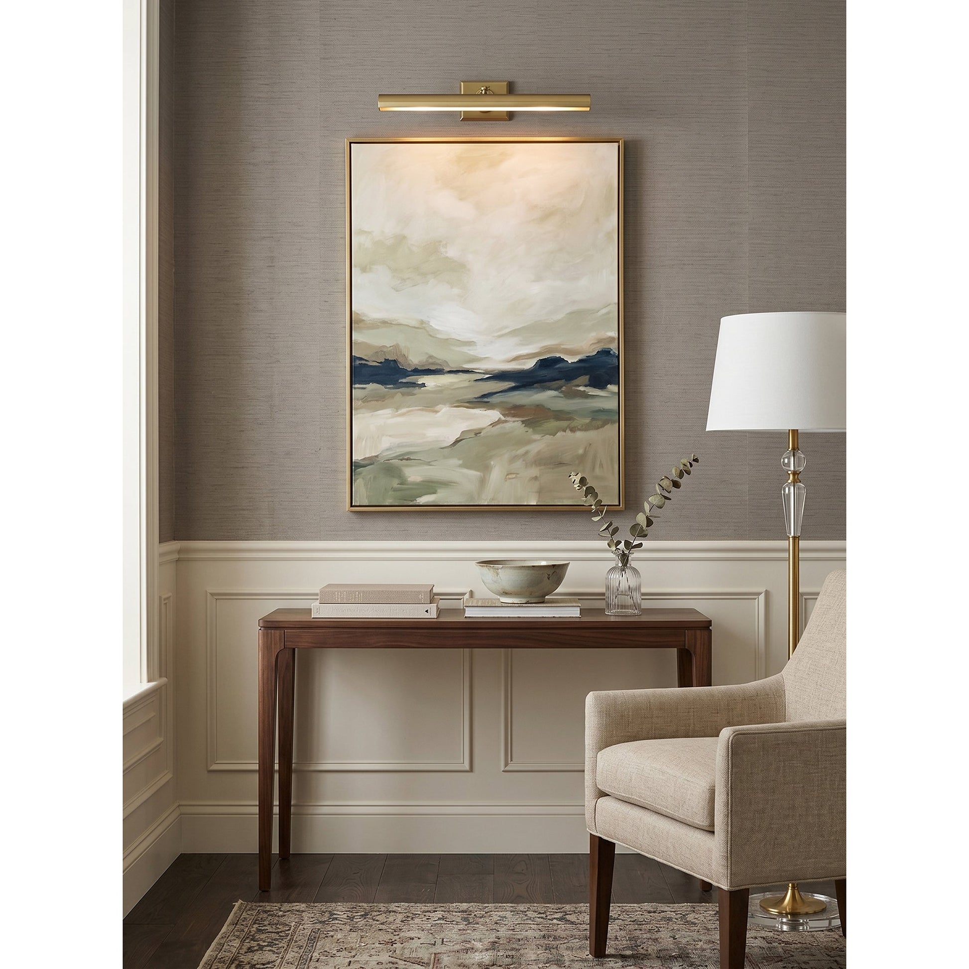 The Bilbury wall sconce installed over a painting in a gallery setting.