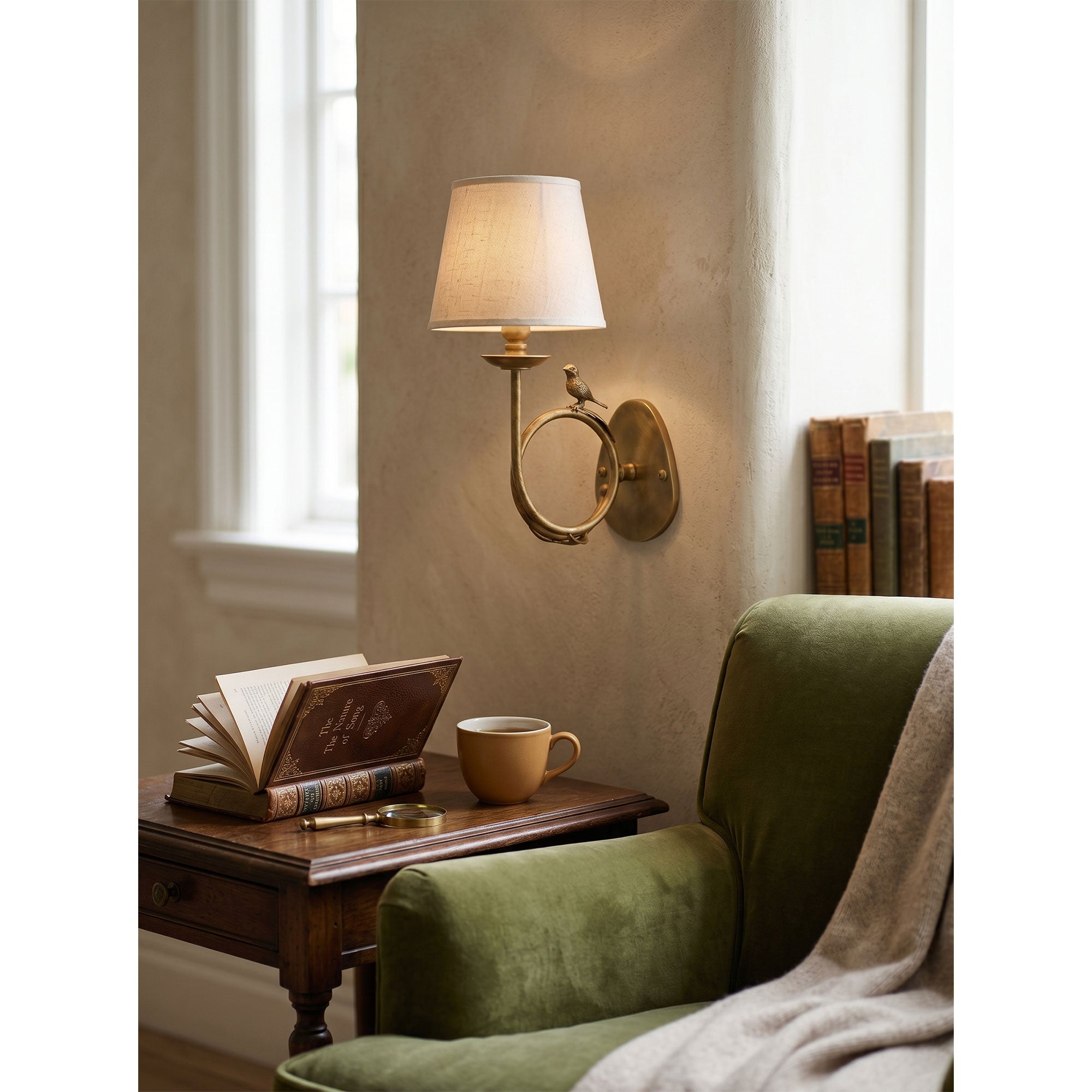 Detail shot of the polished brass finish on the sconce's arm.