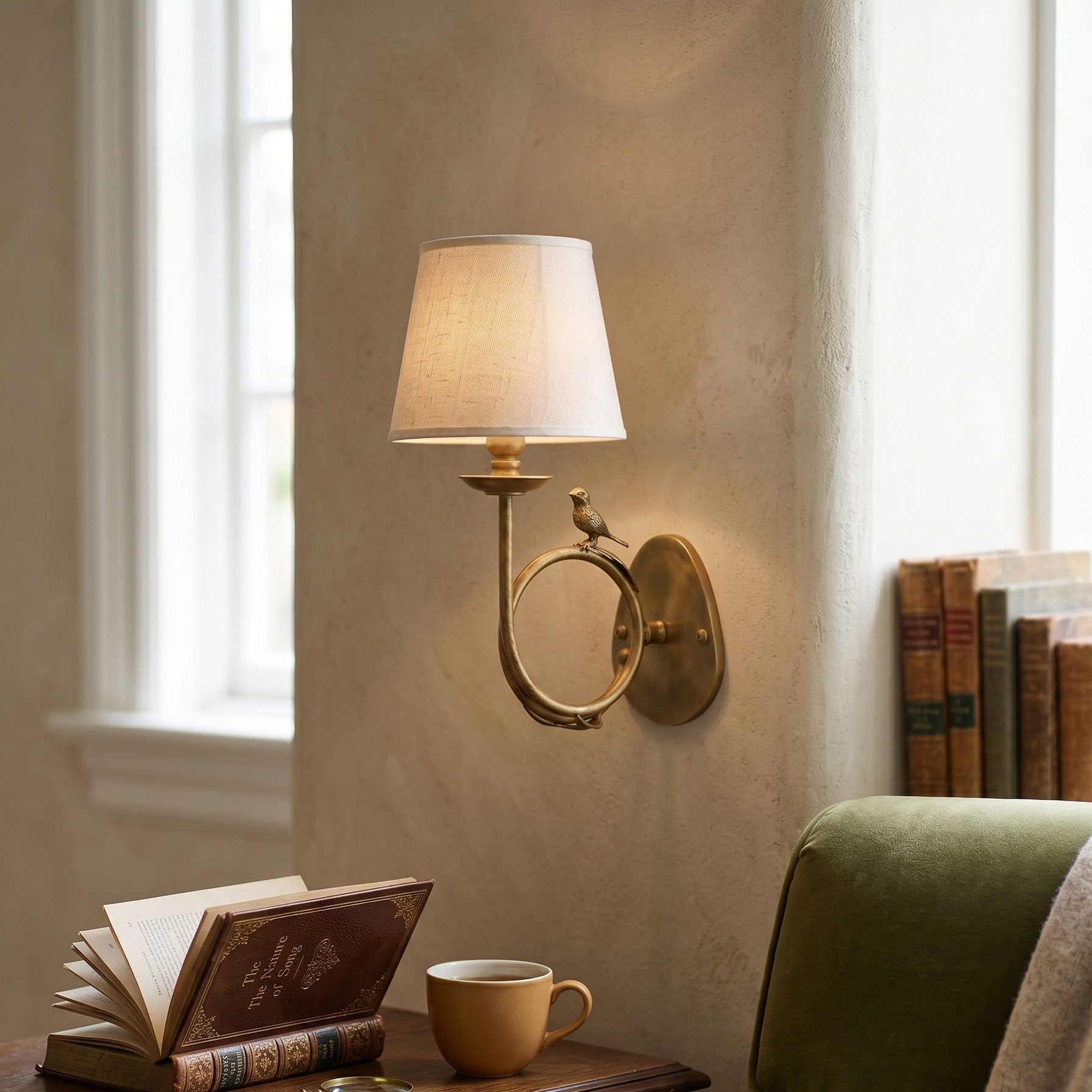 Close-up shot of the intricate brass bird detail on the wall sconce.