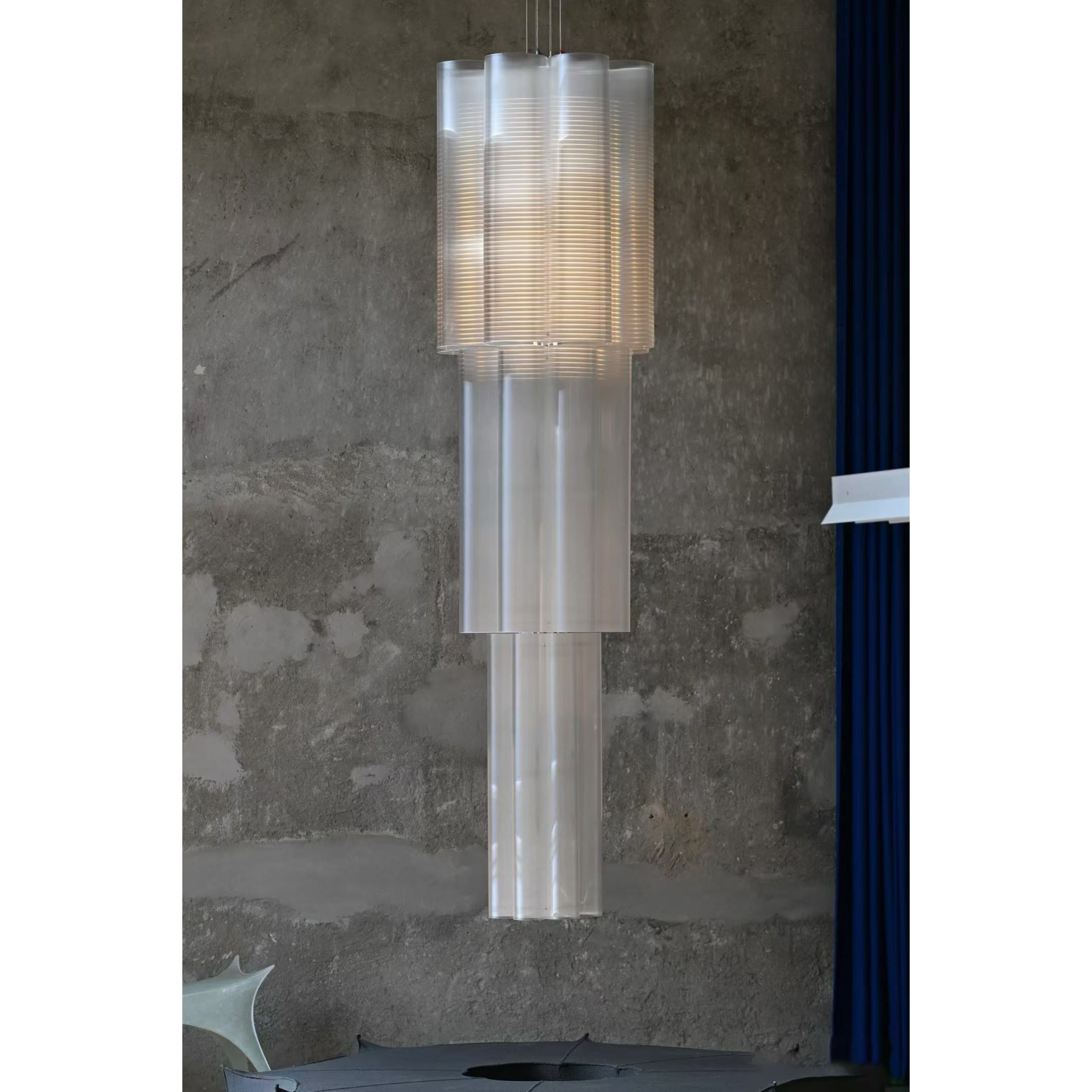 Side profile of the Bloom Chandelier against a neutral wall.