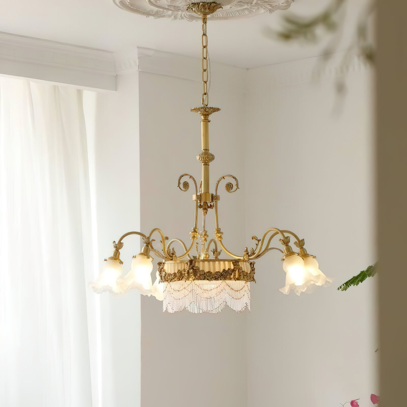 Close-up view of the cascading fringe on the chandelier's central drum shade.