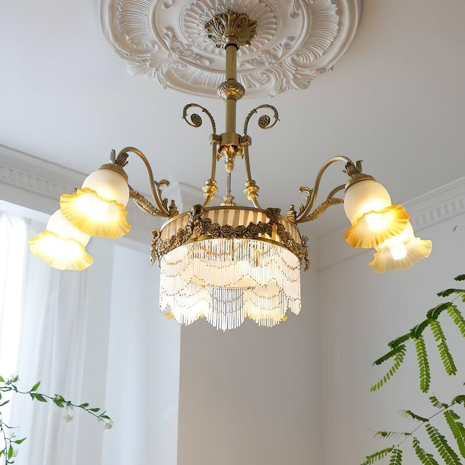 The Camille Chandelier hanging in a glamorous primary bedroom suite.