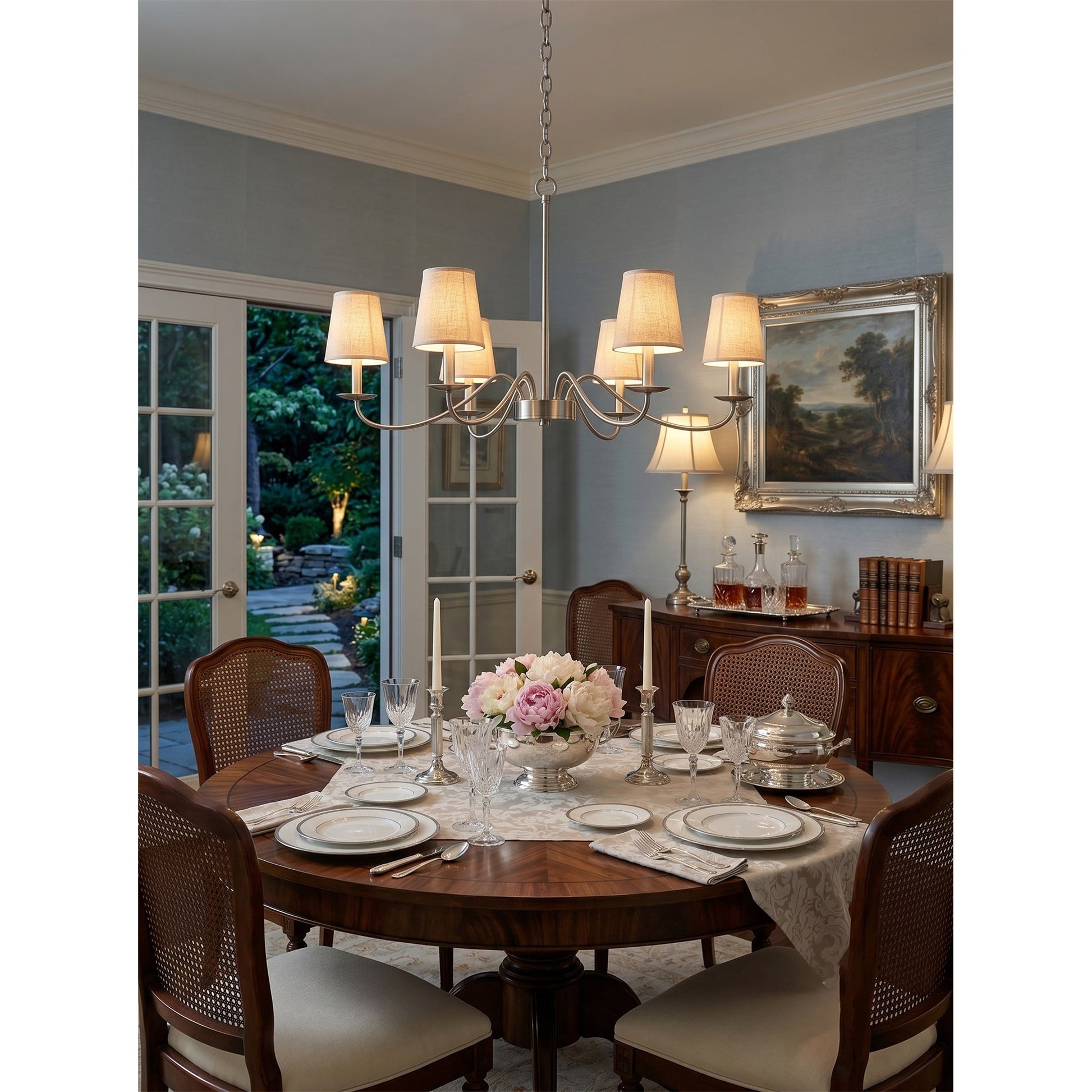 Candler Chandelier illuminated in a high-ceiling entryway.