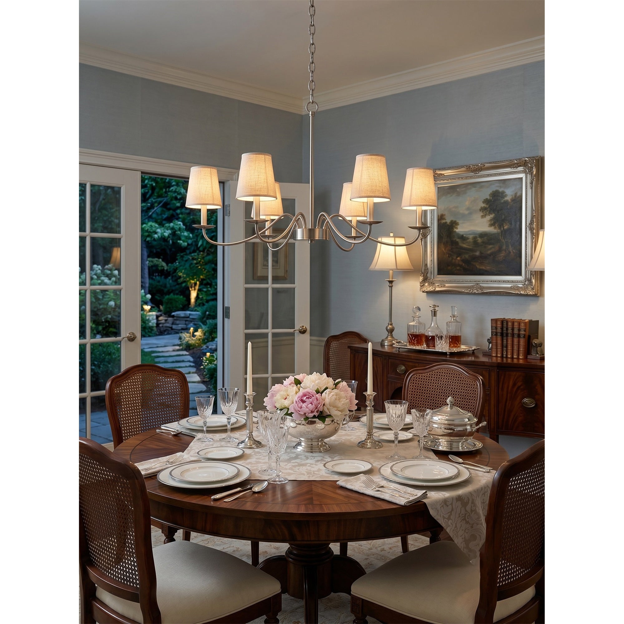 Candler Chandelier illuminated in a high-ceiling entryway.