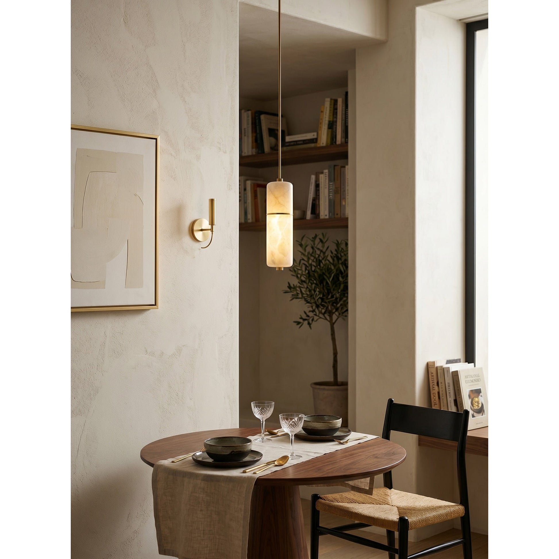 Angled view of the staggered alabaster cylinders of the Cannula Chandelier.