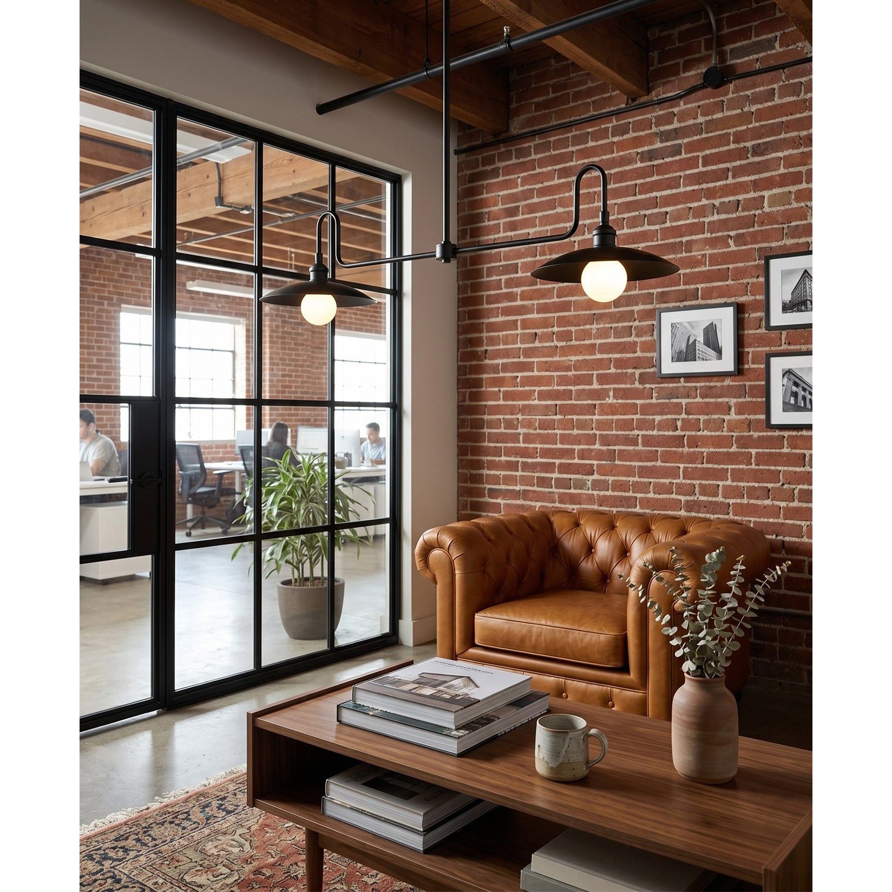 The linear chandelier illuminating a long wooden dining table.