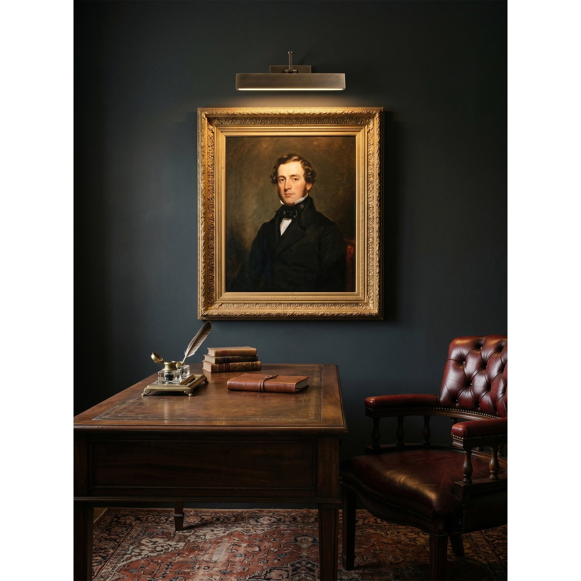 Carlisle picture light illuminating a framed photo on a dark wall.