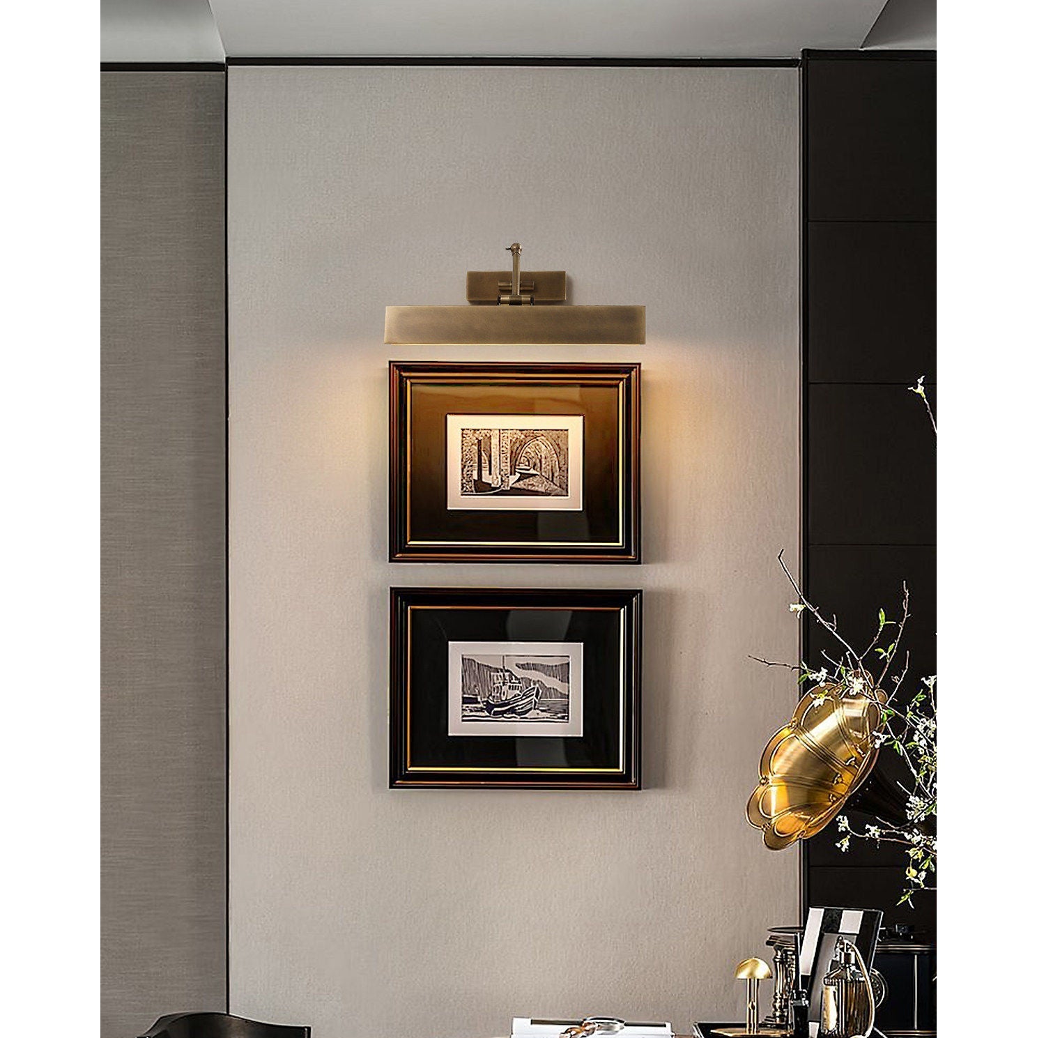 The rectangular back panel of the wall sconce against a wall.