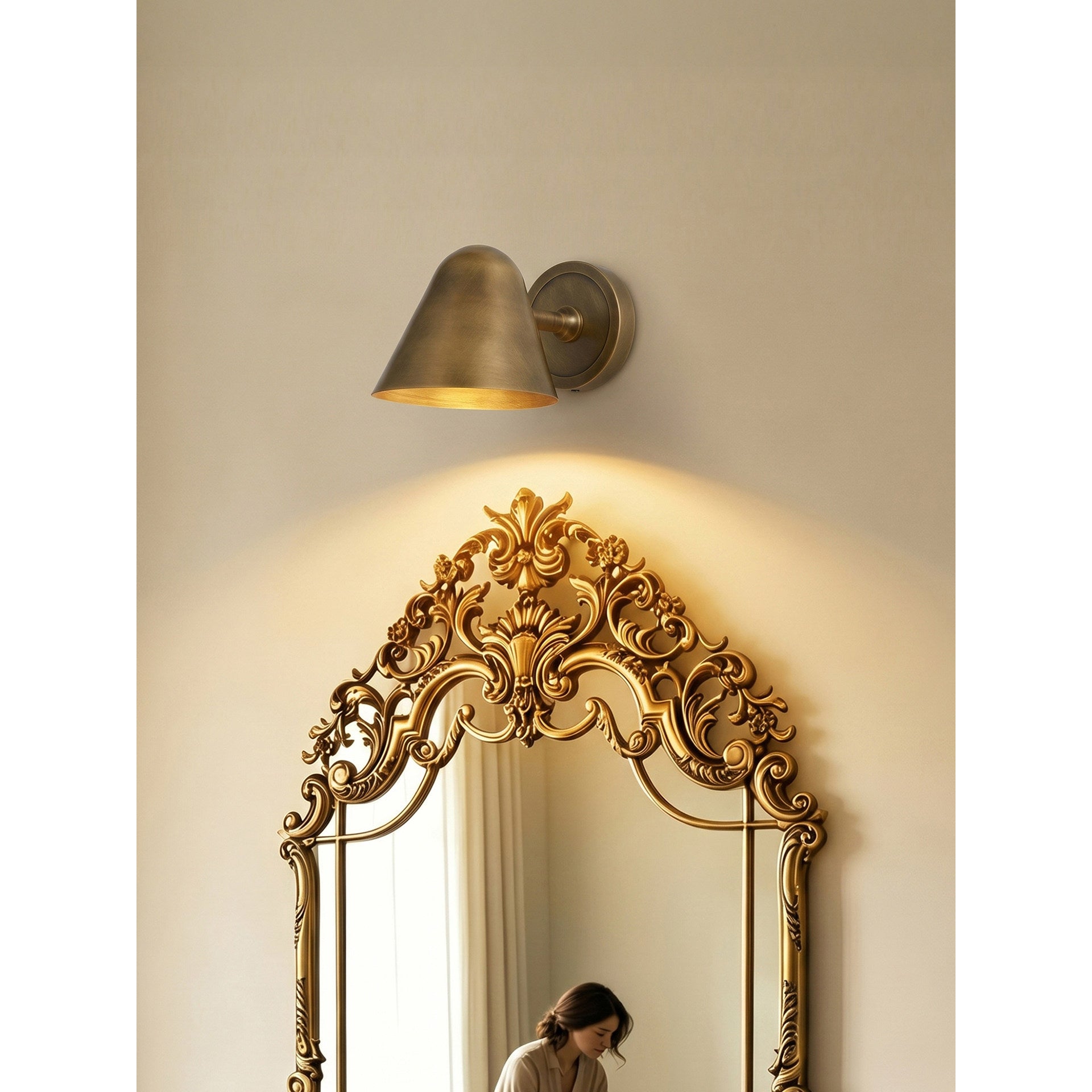 Detail view of the wall mounting backplate in brass.