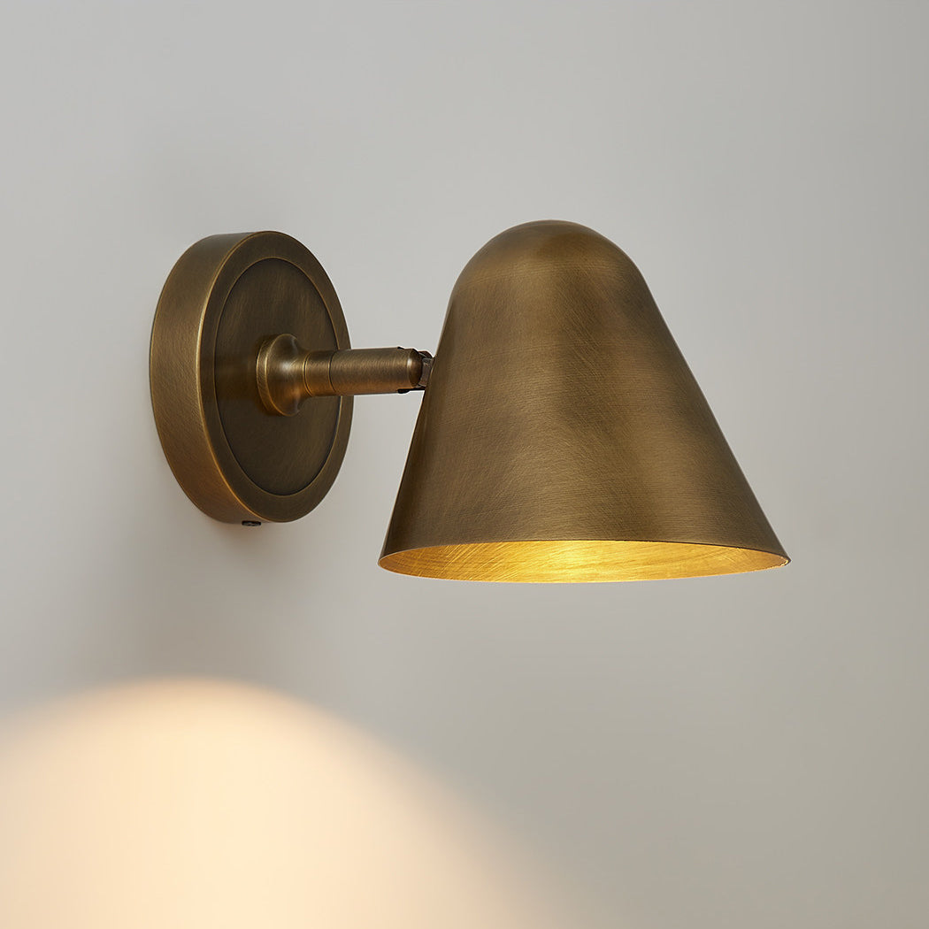 The black sconce featured in an urban loft-style room.