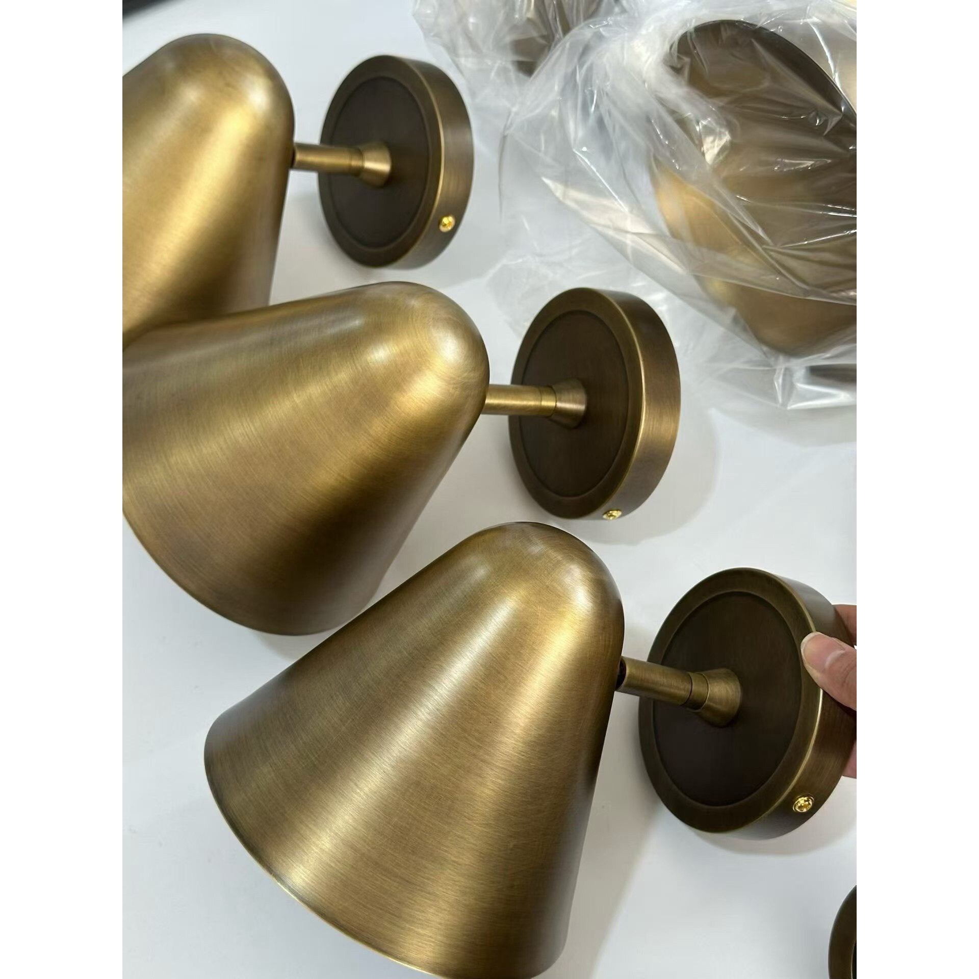The black sconce shown unlit against a neutral background.