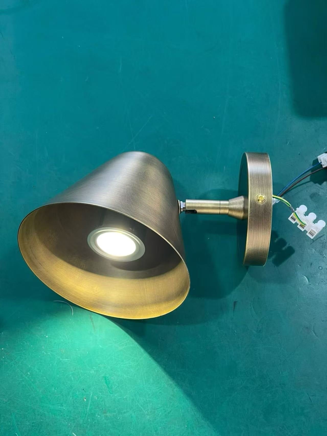 The antique bronze sconce shown unlit against a neutral background.