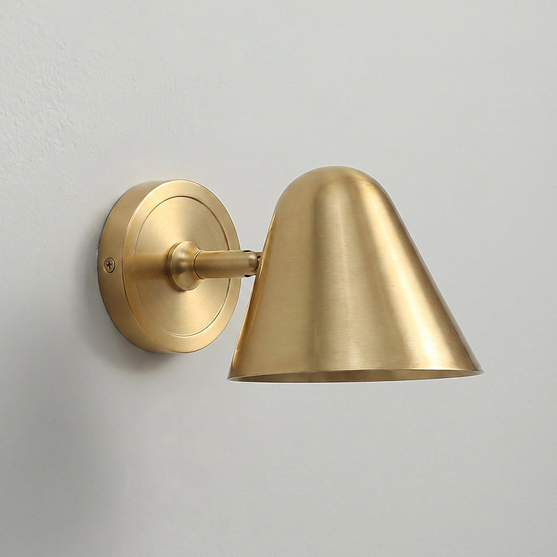 The wall sconce used to highlight a piece of artwork.
