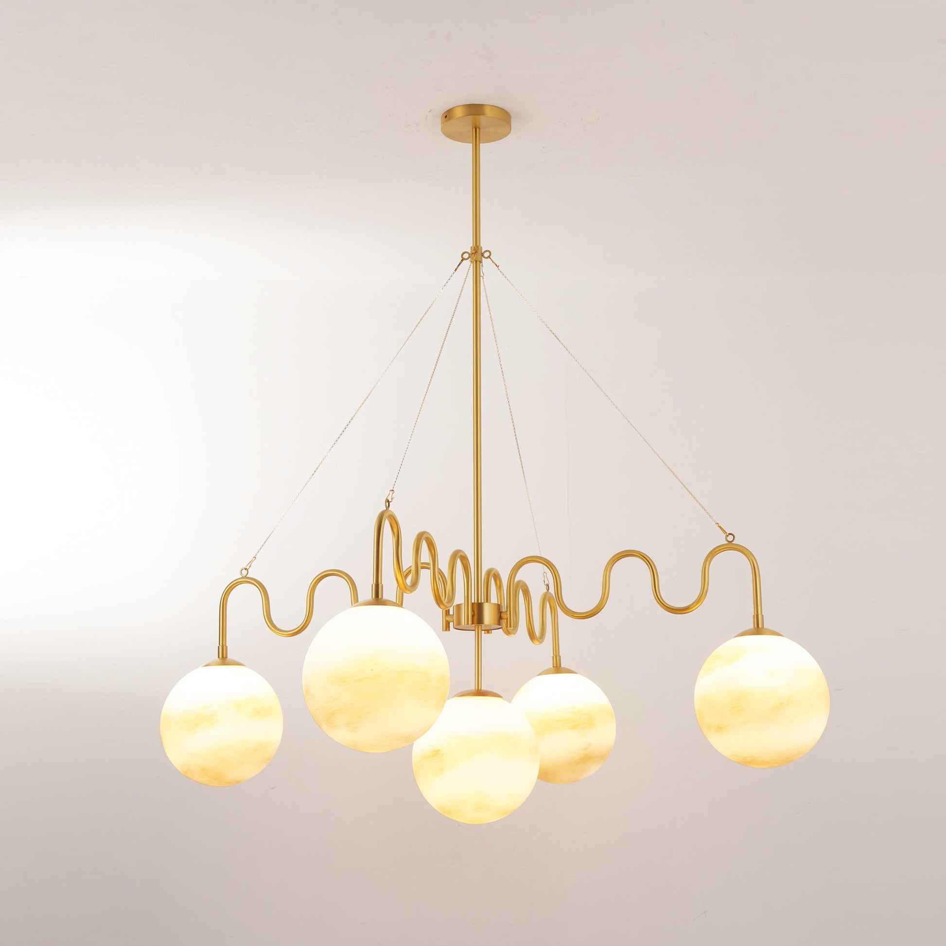 Studio shot of the full brass chandelier on a white background.