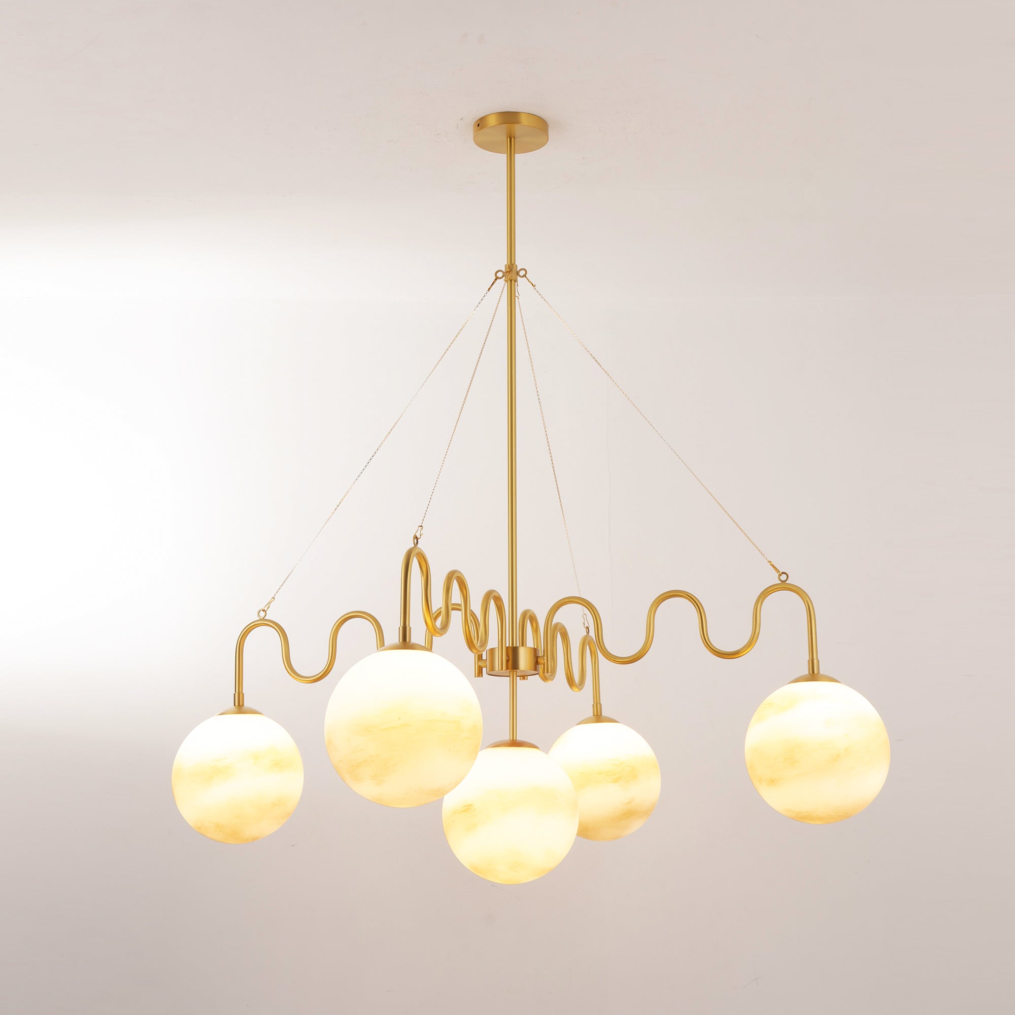 Studio shot of the full brass chandelier on a white background.