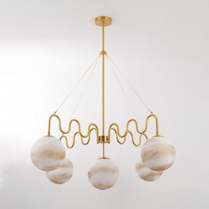 The Cecil Chandelier in black finish providing light over a kitchen island.