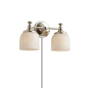 Chart Alabaster Plug-in Wall Sconce in brass finish against a light wall.