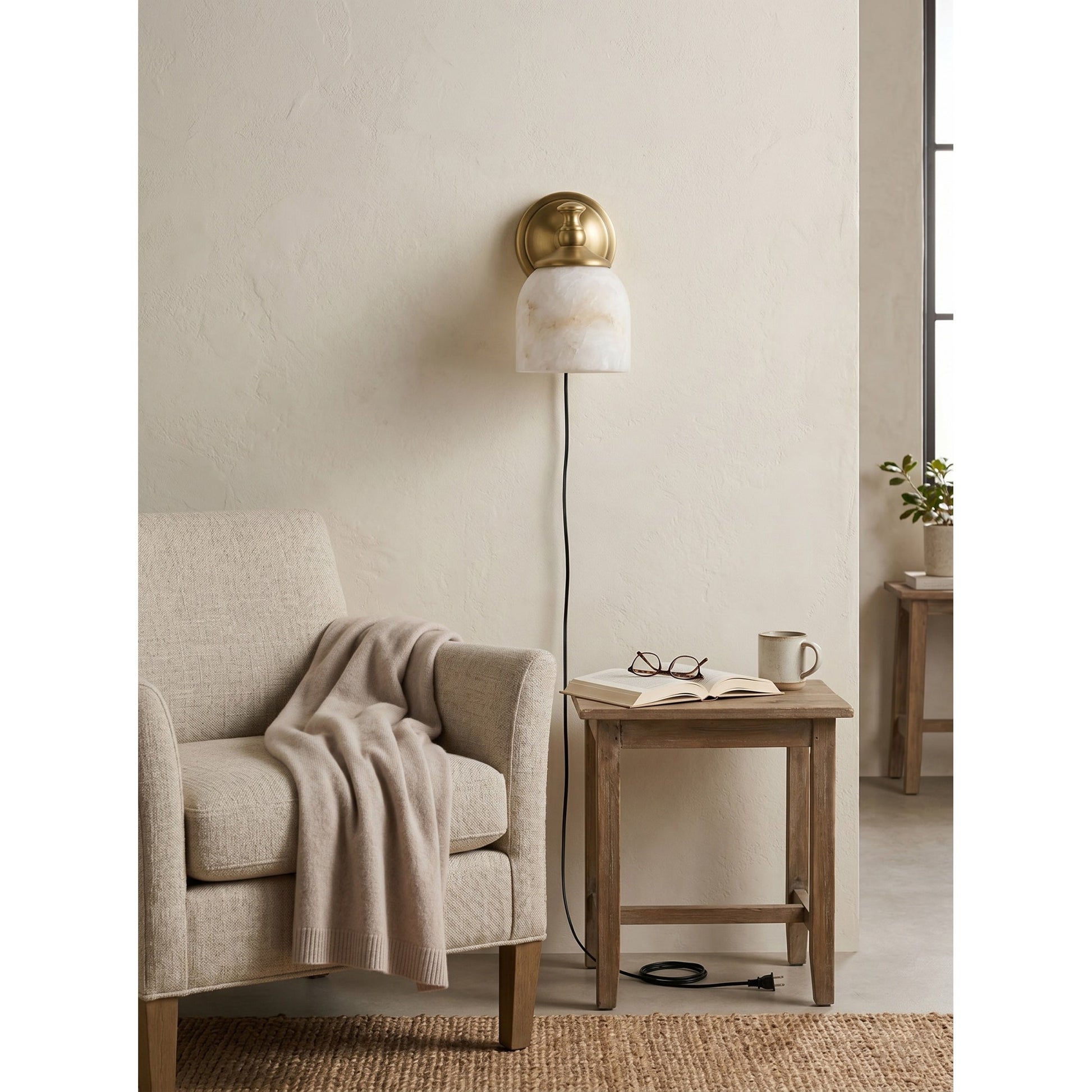 Lifestyle view of the Chart sconce illuminating a home office nook.