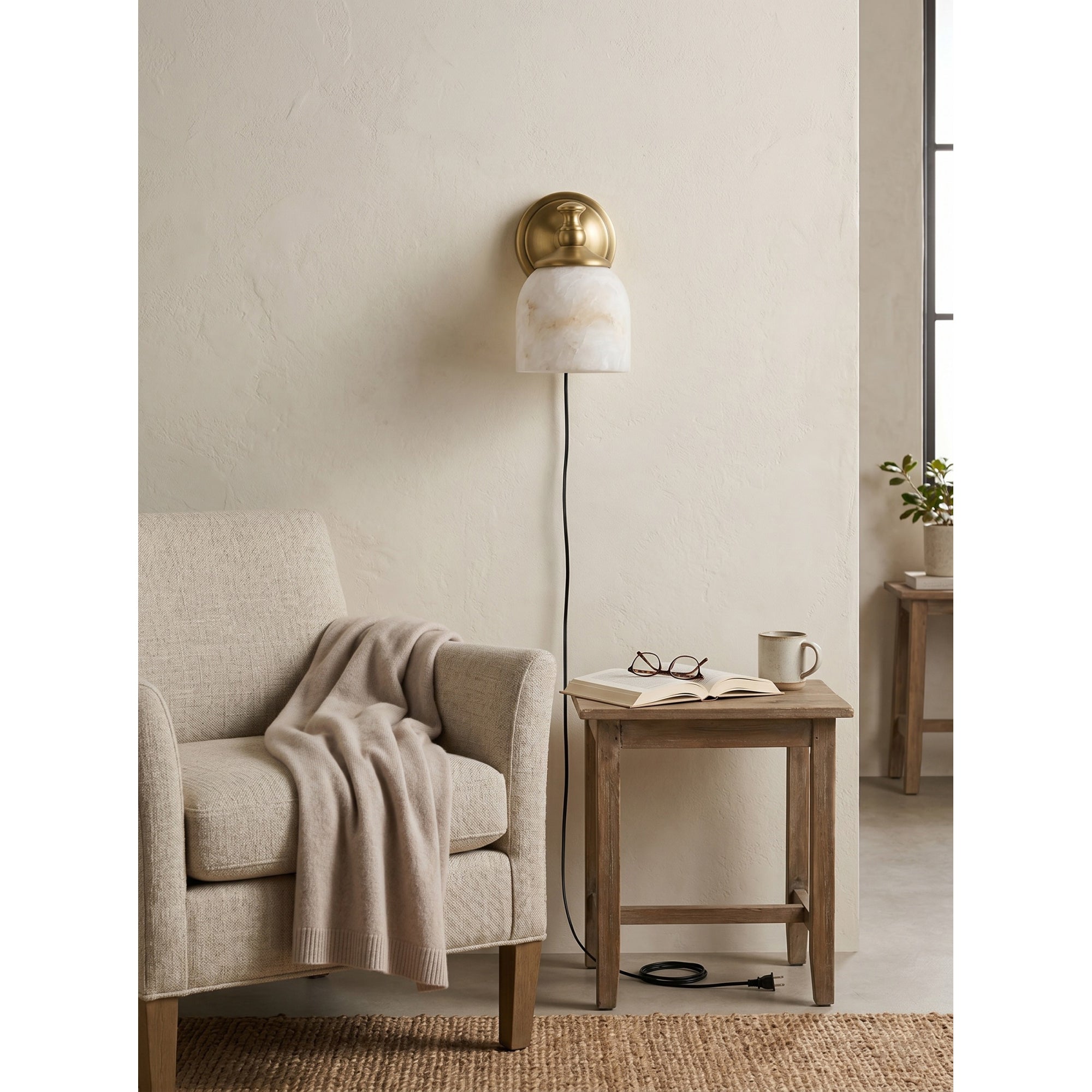 Lifestyle view of the Chart sconce illuminating a home office nook.
