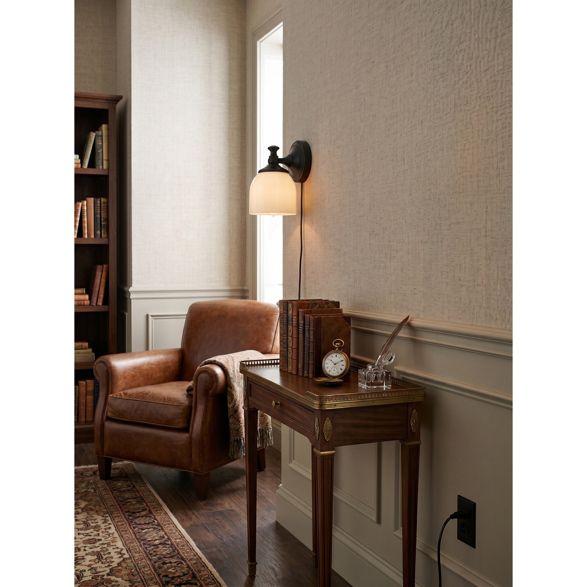 Angled view of the single-head brass sconce.