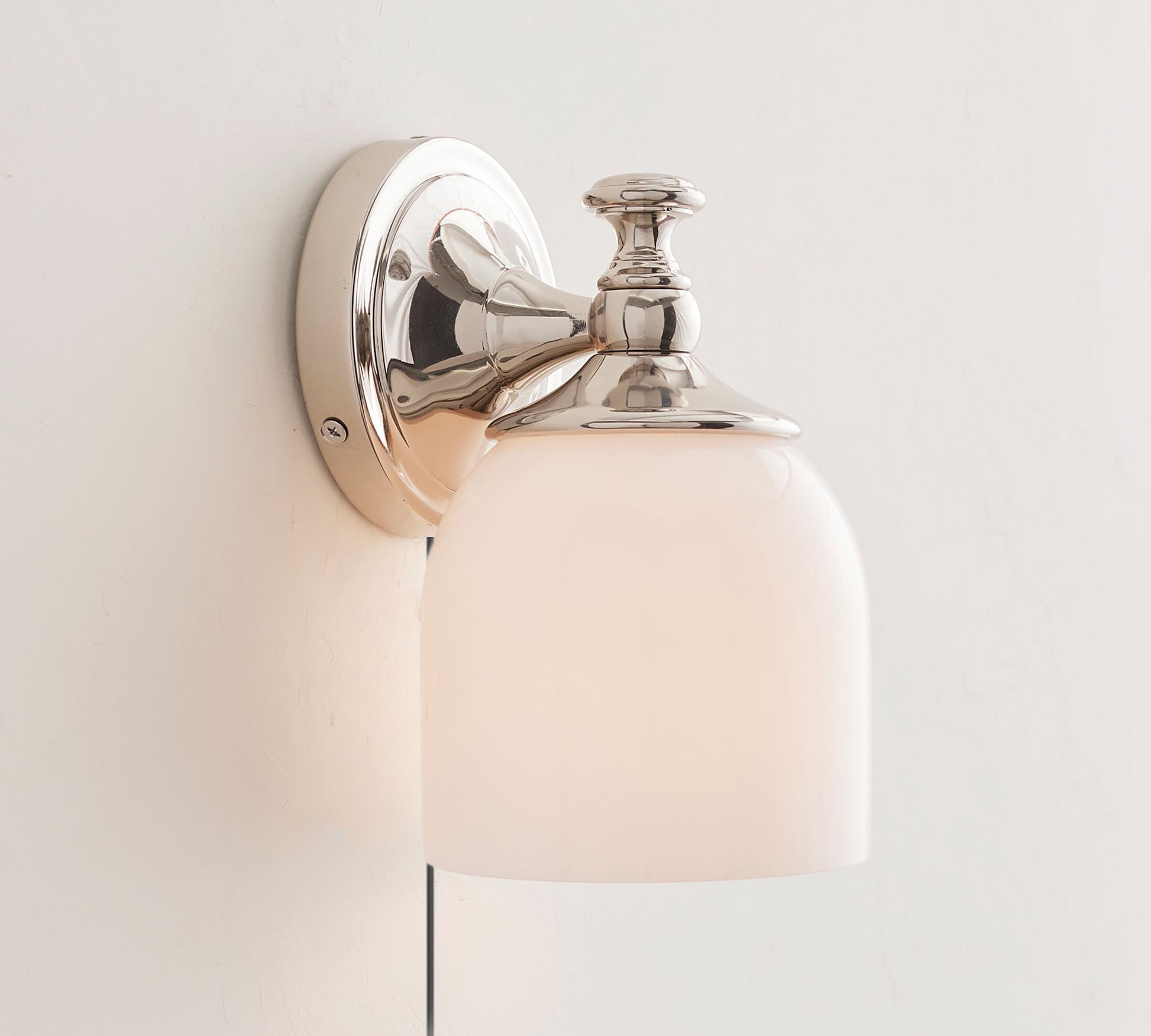 The 2-head nickel sconce installed in a hallway.