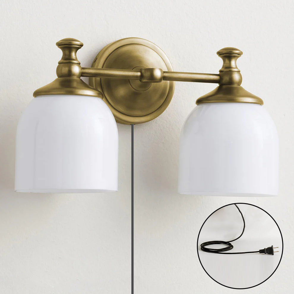 The 3-head black sconce positioned over a console table.