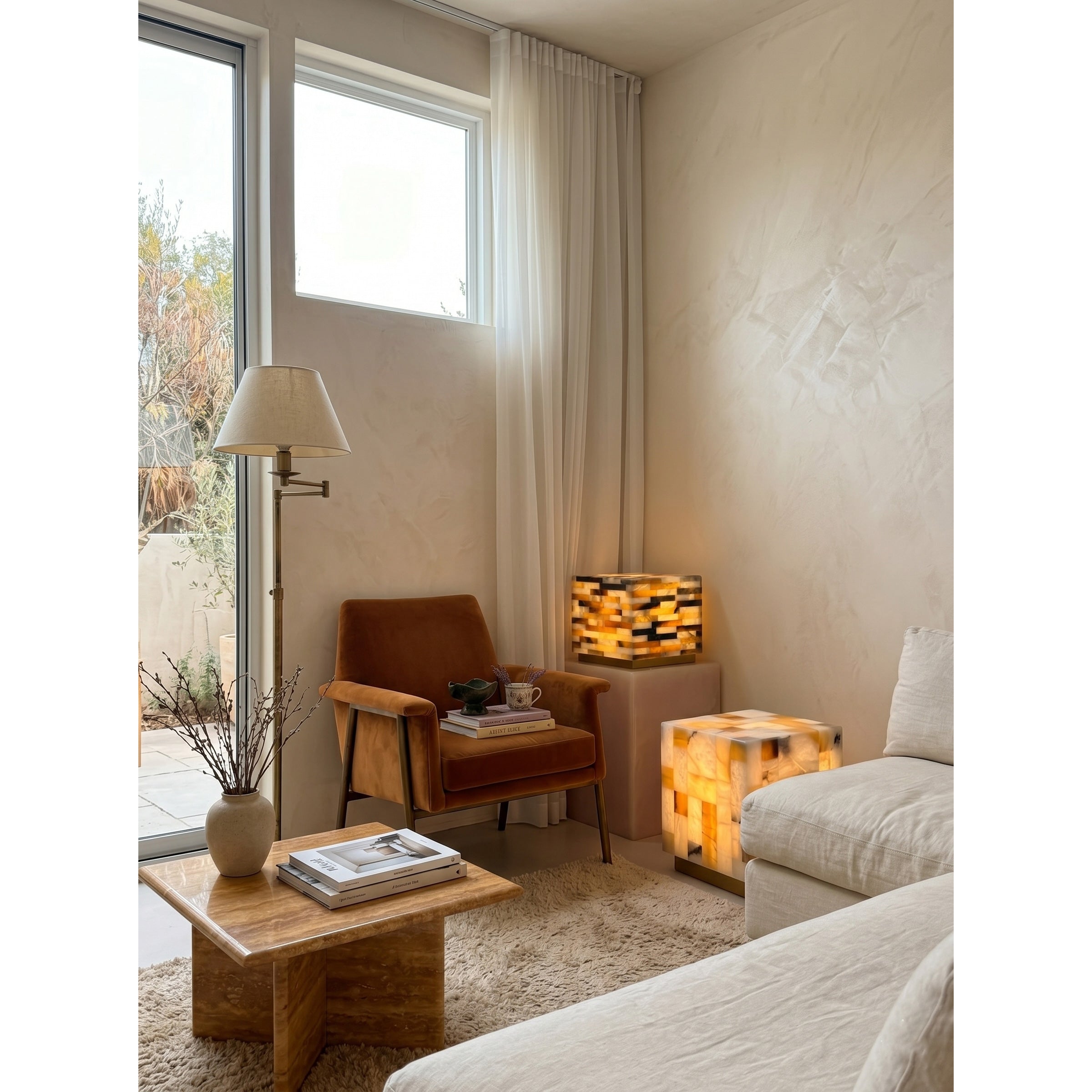 Lifestyle image of the alabaster lamp in a living room.