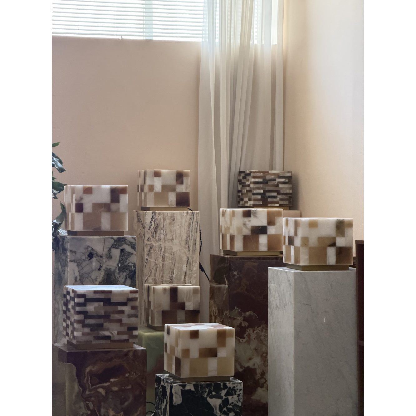 Angled view of the square cube alabaster table lamp.