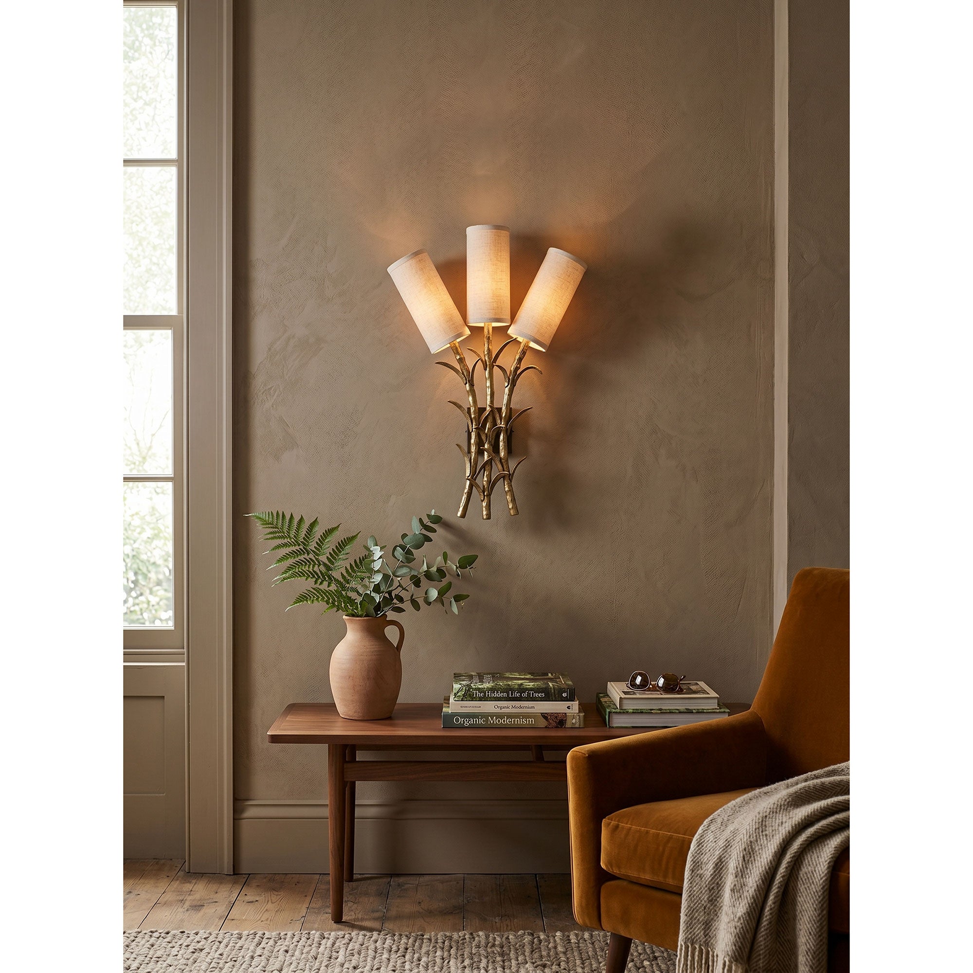 The Chelsea Wall Sconce turned on, casting a warm, diffused glow.