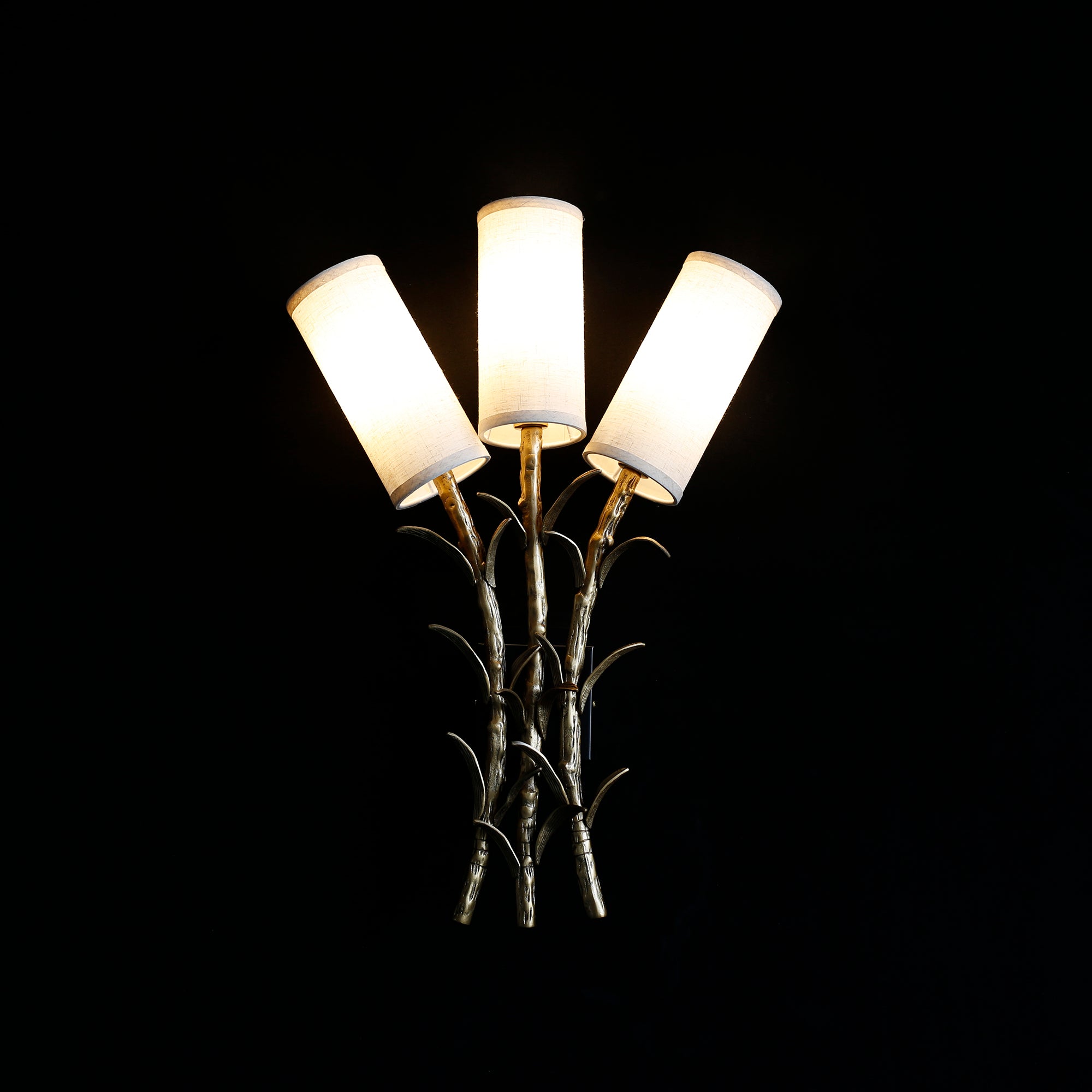 The Chelsea Wall Sconce shown with a compatible dimmer switch in a living space.