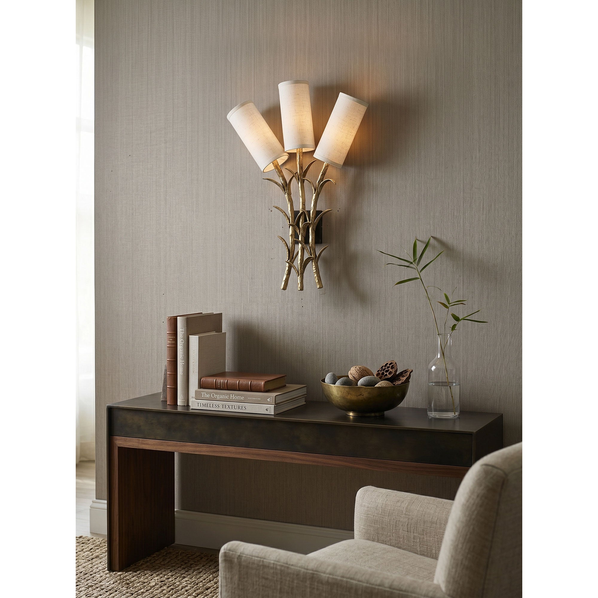 The Chelsea Wall Sconce providing ambient light in a chic dining room setting.