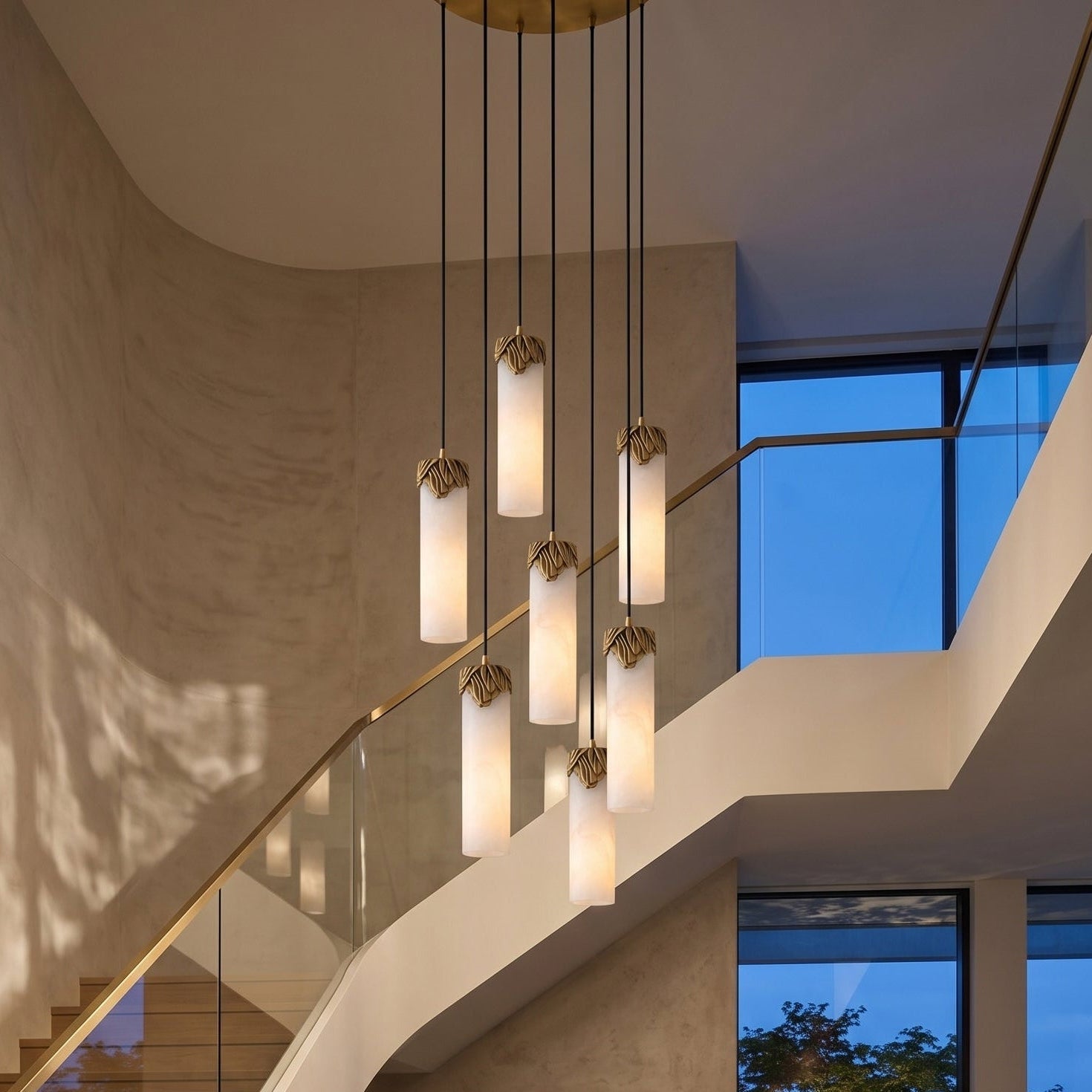 Close-up of a veined alabaster cylinder shade on the Lyra chandelier.