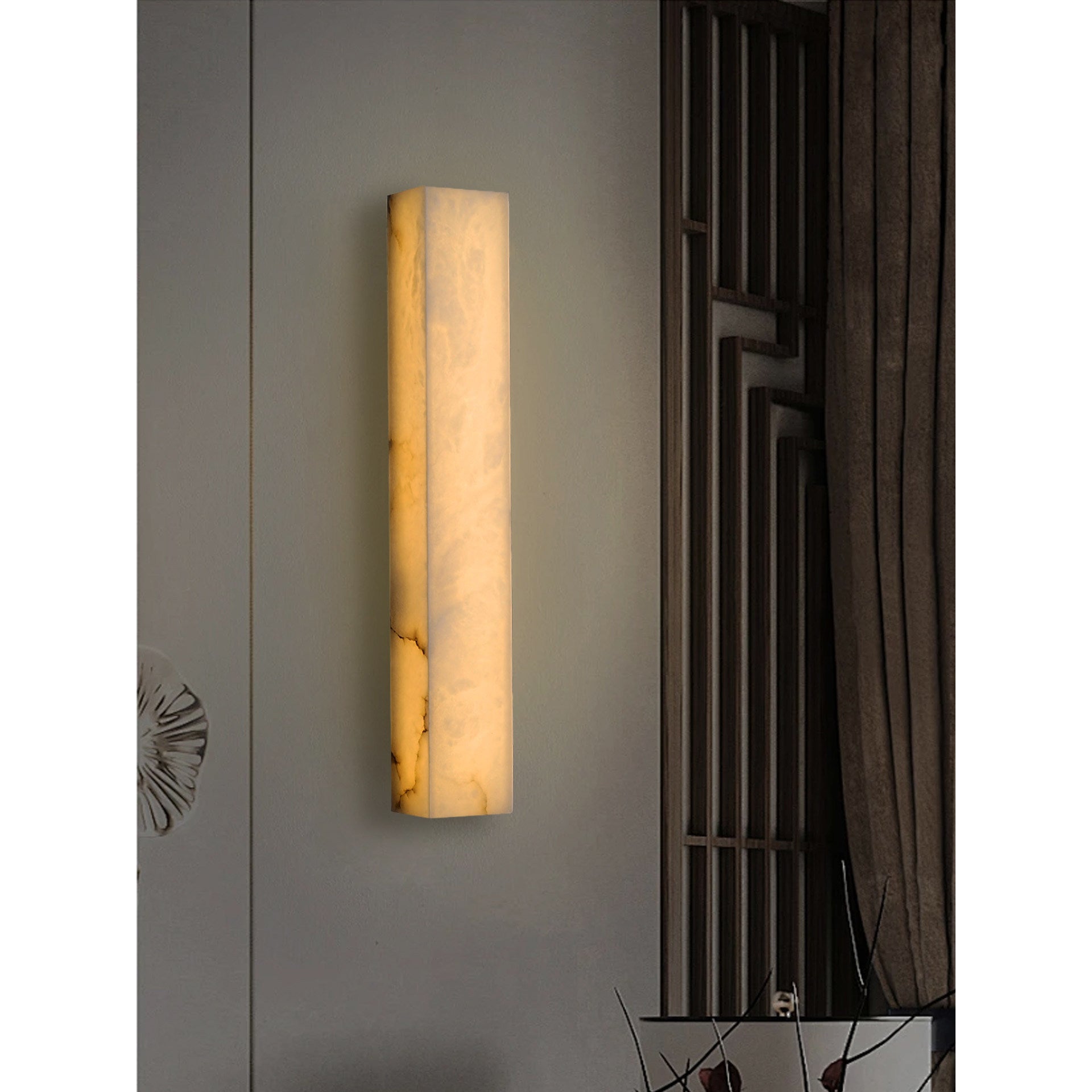 Dara wall sconce mounted on a textured wall.