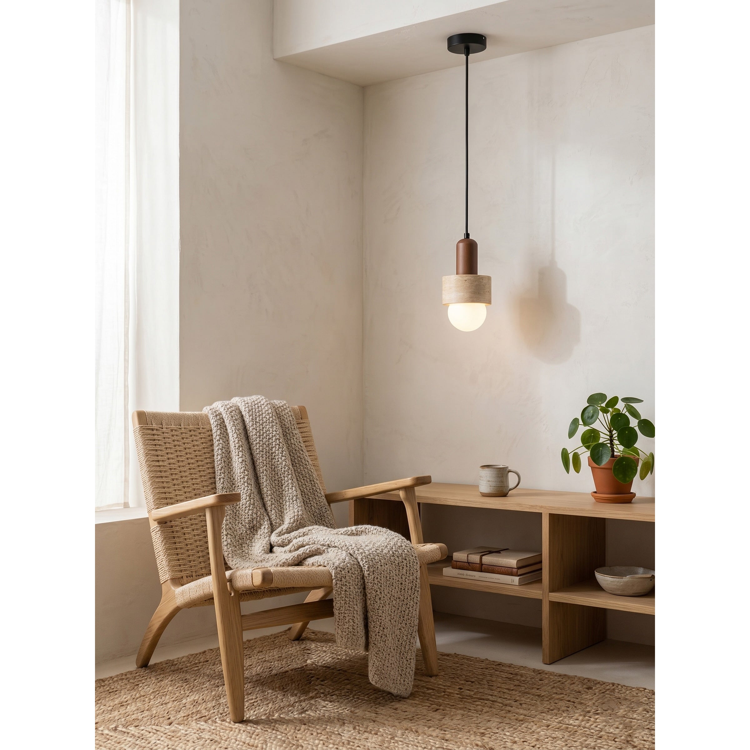 The sculptural form of the Davise Pendant Lamp against a neutral wall.