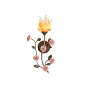 Ember & Blossom Wall Sconce with floral design against a neutral wall.