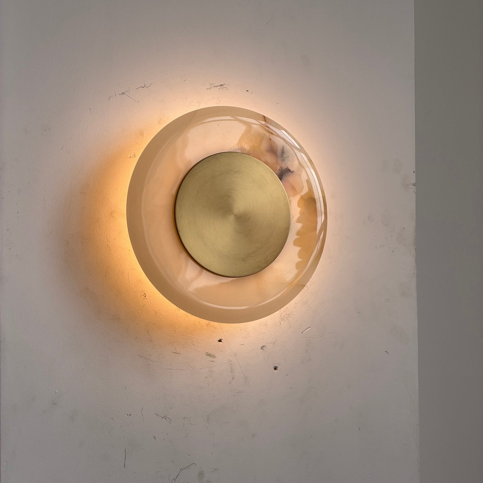 The White Onyx sconce shown unlit to highlight the material texture.