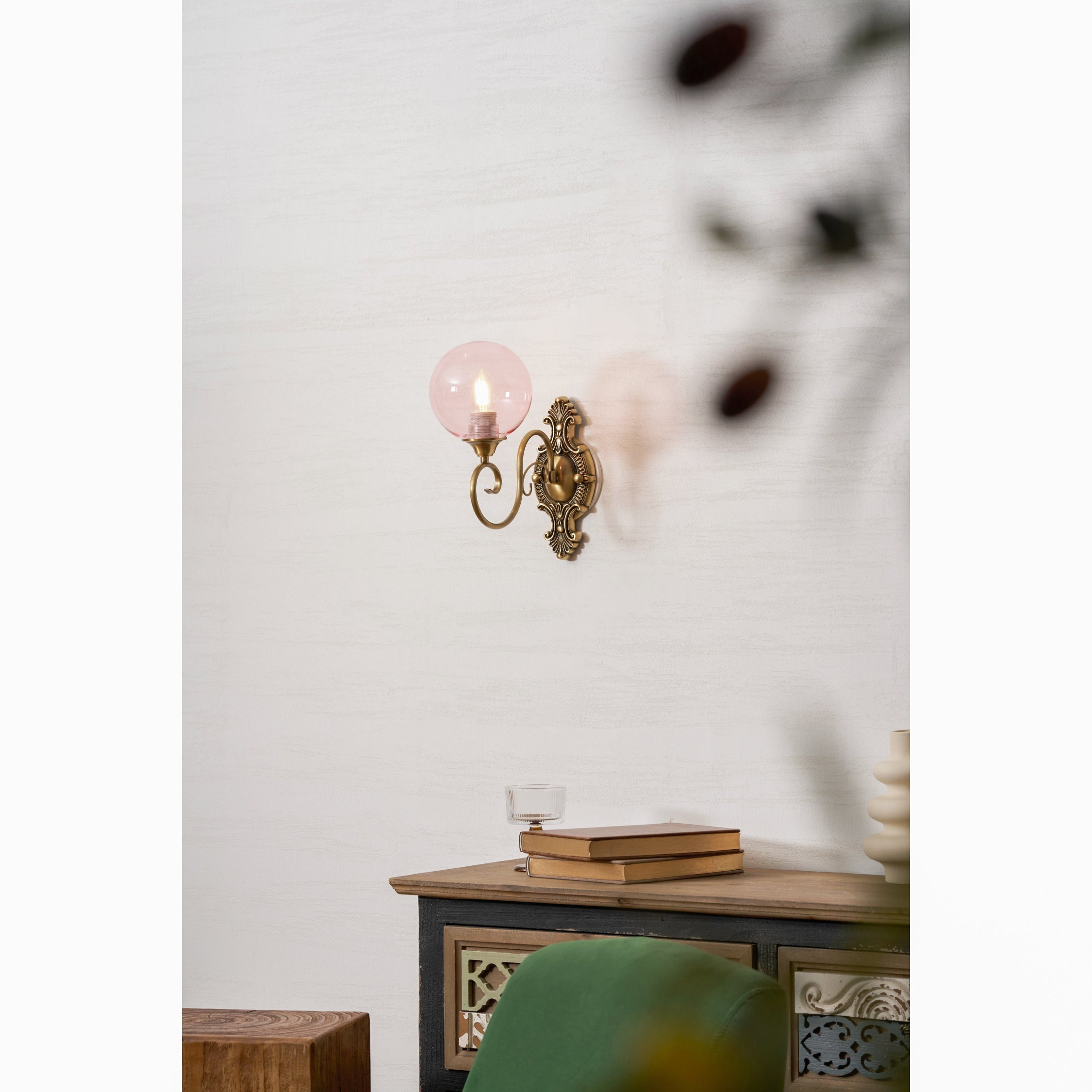 The Evelyn Wall Lamp in pink finish, angled view.