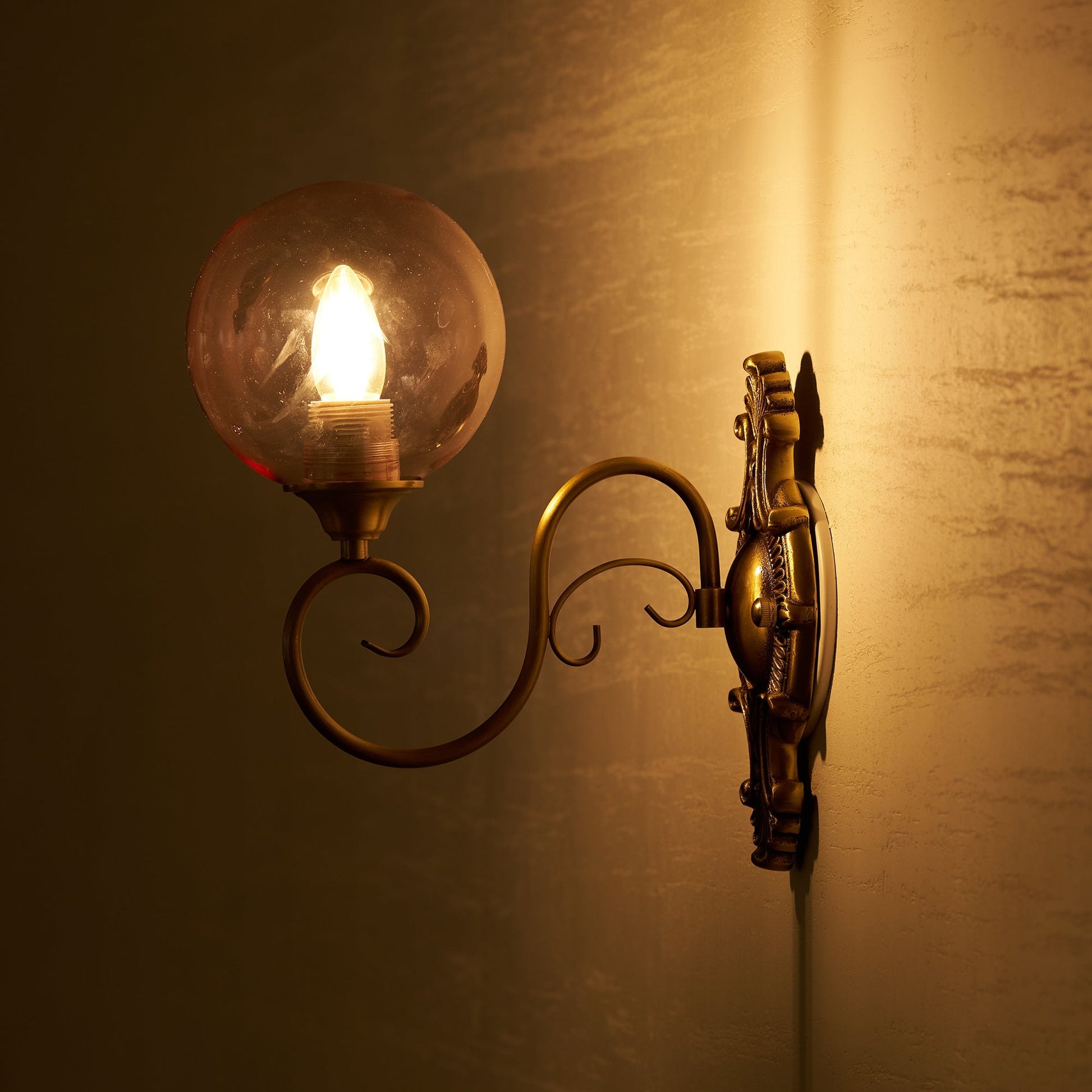 The Evelyn Glass Wall Lamp with a classic white glass shade.