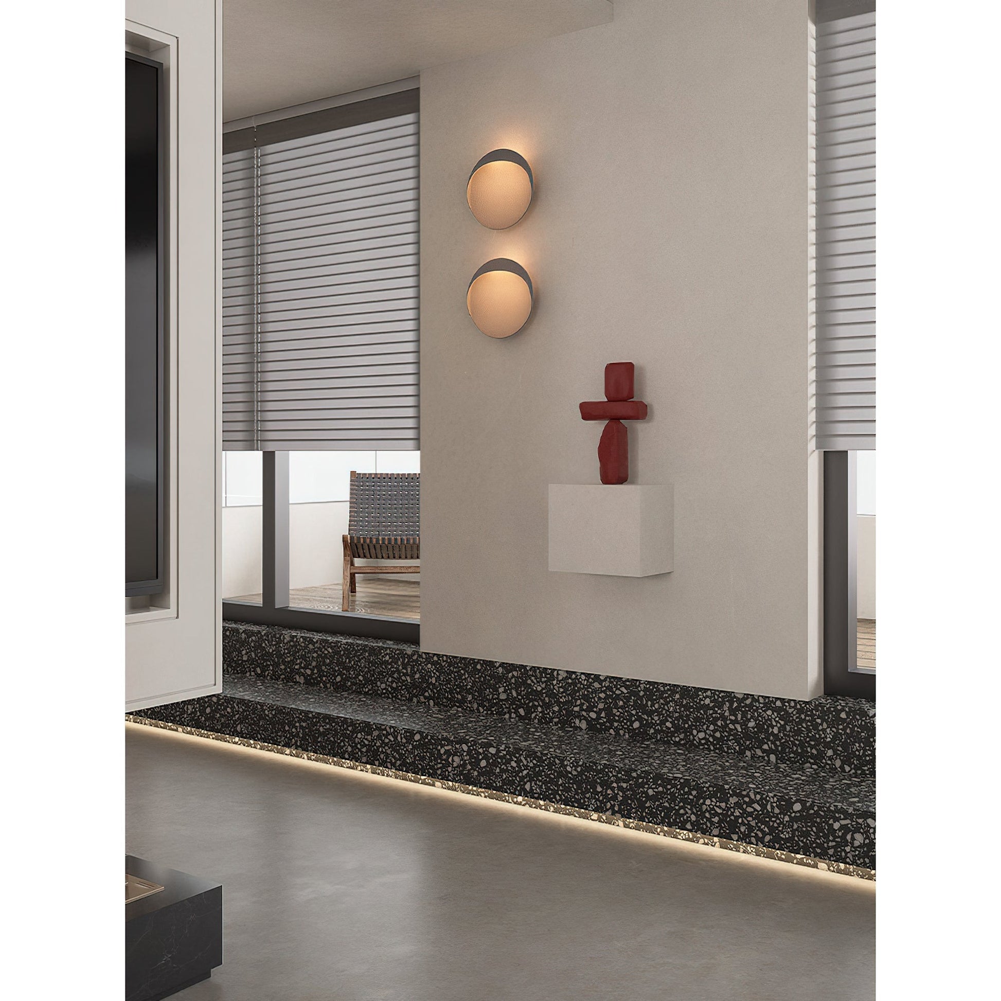 Black Flindt sconce providing accent lighting in an entryway.
