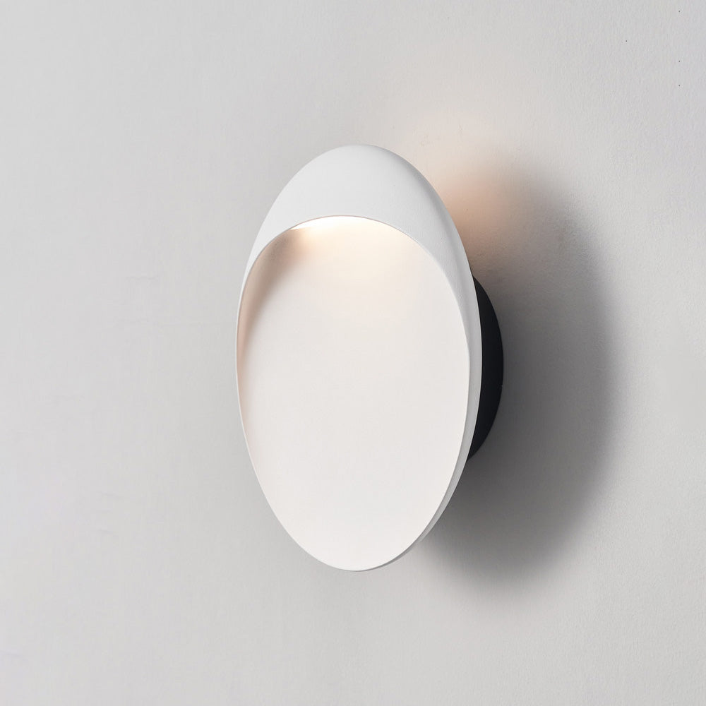 Coffee-colored Flindt sconce in a cozy reading nook.
