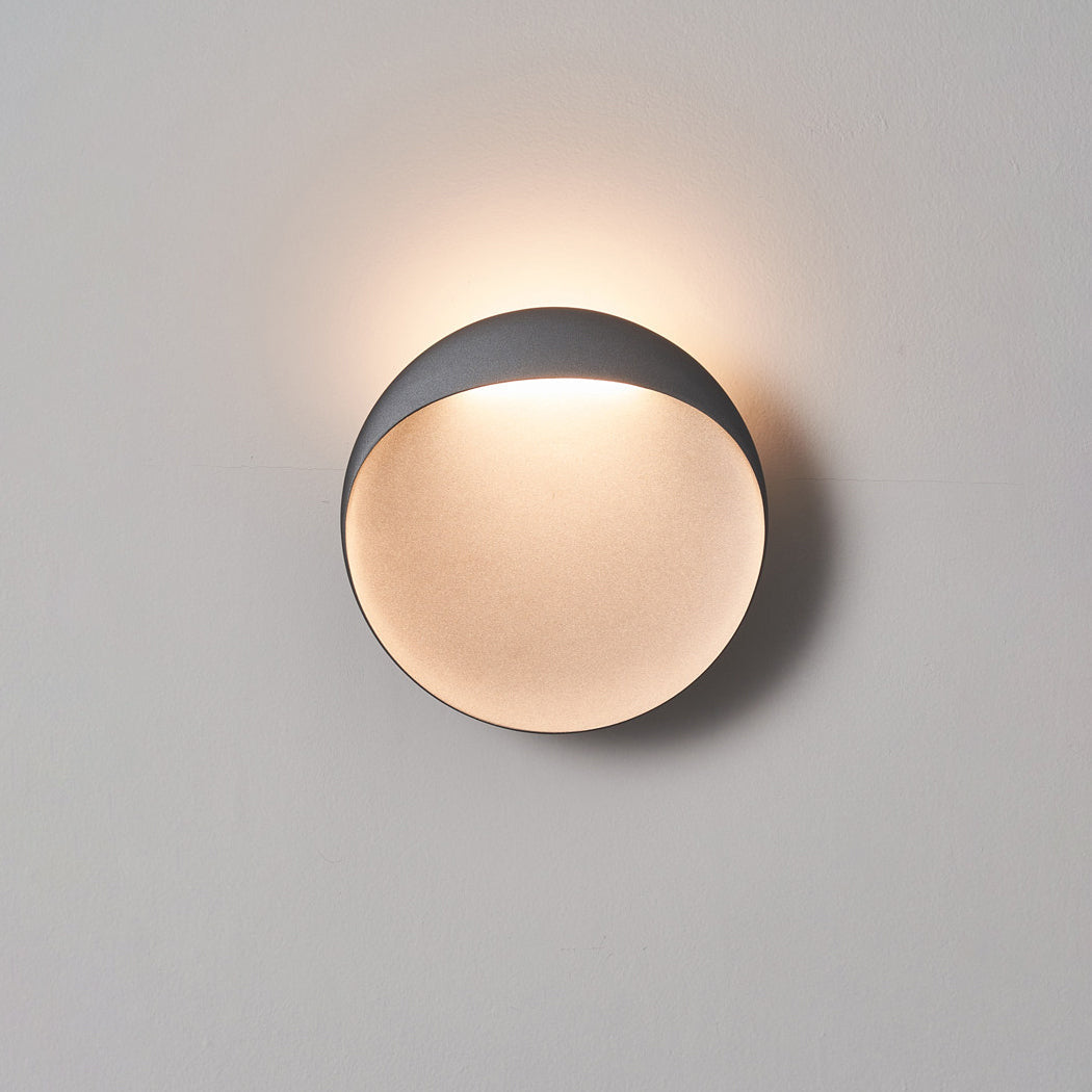 Angled shot of the white Flindt sconce showing its depth.